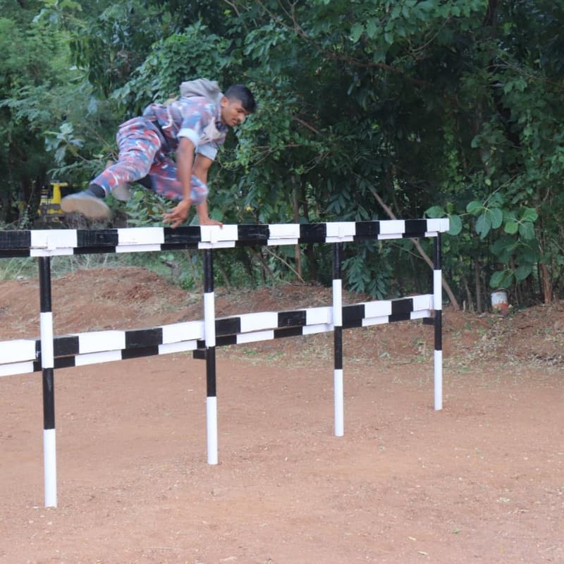 A cadet clearing a hurdle on the obstacle training course